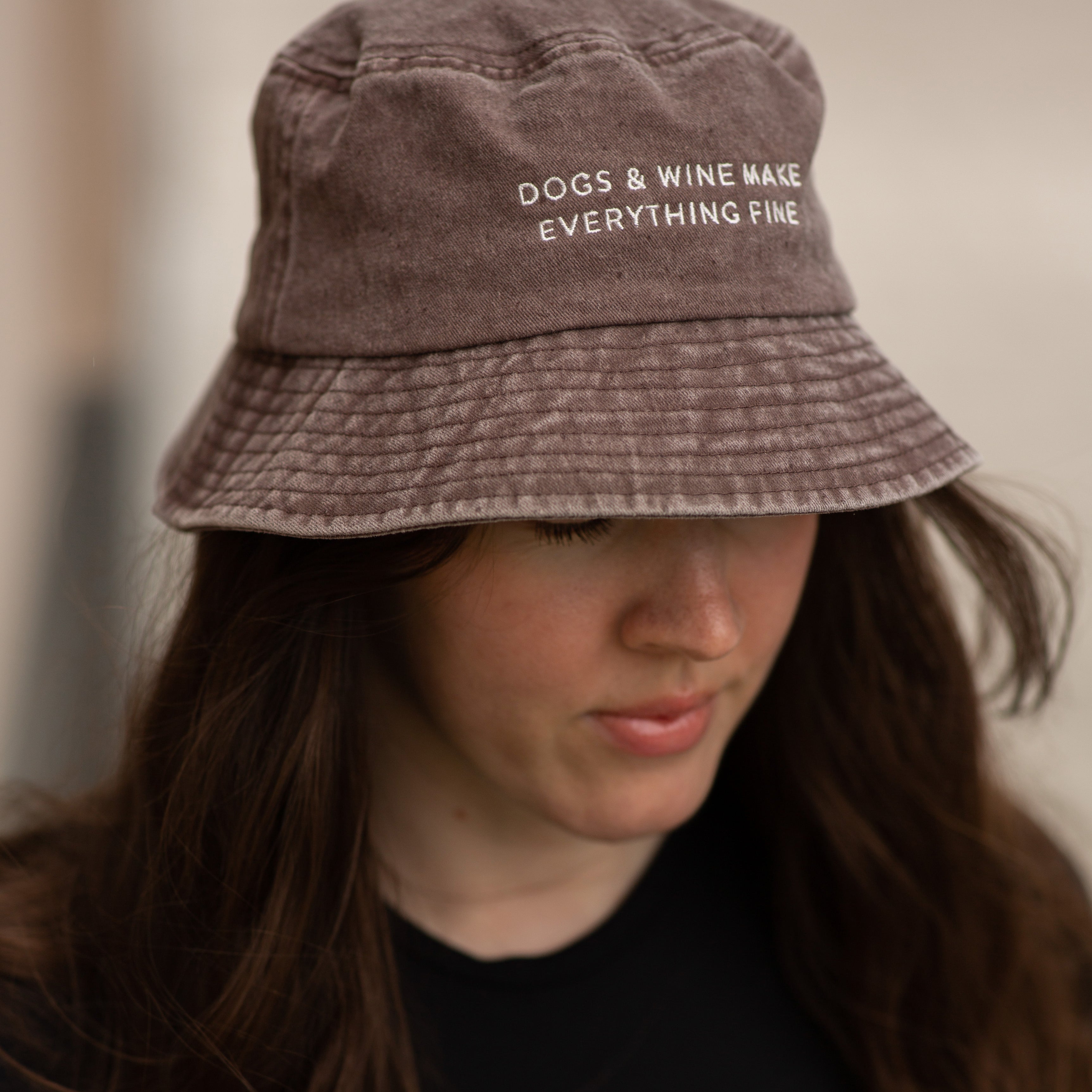 brown-bucket-hat-dogs-and-wine-make-everything-fine-wearing-woman.jpg